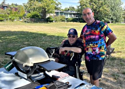 VSRA Director Bill Cox and volunteer Peter Mercanti at the grill cooking hot dogs.