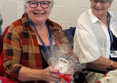Two smiling woman at the VSRA Thanksgiving lunch, October 2025.