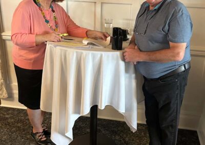 A smiling man and woman at the small welcoming table