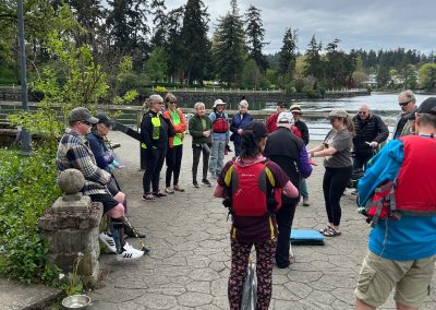 A group of people standing outside in life preservers