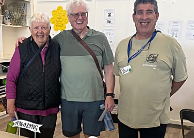 Three older people standing and smiling