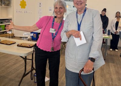 Two woman standing smiling