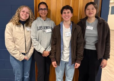 four young adults smiling