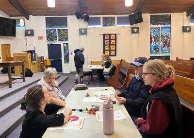 People sitting at a table with papers in front of them, talking
