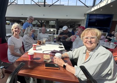 A group of men and women at a table in Hillside Mall's food court